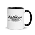 White ceramic mug with black interior and Cold Streets Worldwide logo in dark blue red