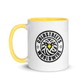 White ceramic mug with yellow handle, Coldstreets Worldwide logo, green orange blue design