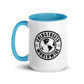 White ceramic mug with blue handle featuring Coldstreets Worldwide logo and continents
