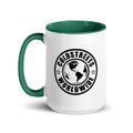 White ceramic mug with green interior featuring Coldstreets Worldwide logo and globe design
