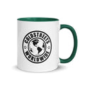 White ceramic mug with green handle and Coldstreets Worldwide logo of the Americas
