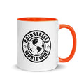 White ceramic mug with orange handle featuring Coldstreets Worldwide logo and globe design