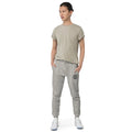 Person in grey casual outfit featuring Cold Streets unisex sweatpants and white sneakers
