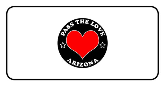 Black badge with red heart and text Pass the Love Arizona, surrounded by stars