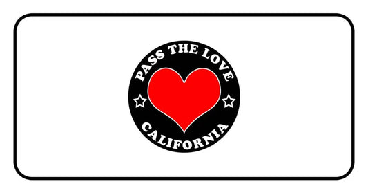 Black circular badge for Pass The Love California with heart, promoting love and clothing