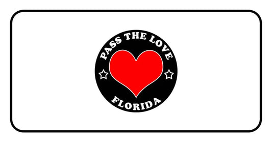 Black circular badge for Pass The Love Florida clothing featuring red heart design