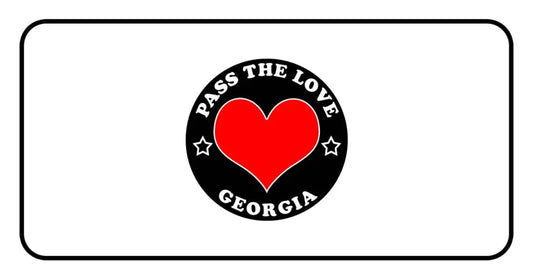 Circular black badge for Pass The Love Georgia featuring a red heart and love theme