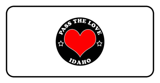 Black badge with red heart and Pass The Love Idaho text, perfect for love-themed clothing