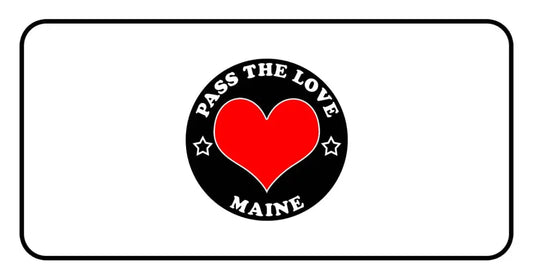 Black circular badge with Pass the Love Maine text and red heart, promoting love and Maine