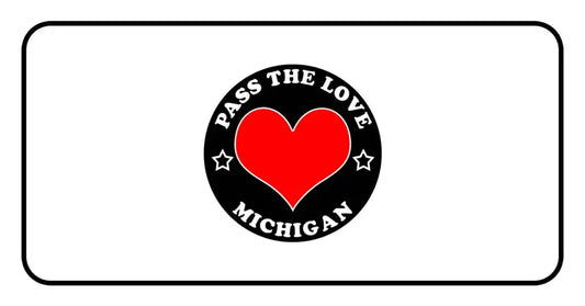 Black circular badge with a red heart and Pass The Love Michigan text for clothing