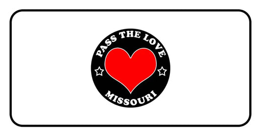 Black circular badge featuring Pass The Love Missouri text and a red heart for clothing