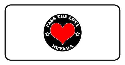 Circular black badge with Pass the Love Nevada text and heart, representing love in Nevada