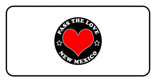 Black circular badge featuring a red heart and Pass The Love New Mexico for clothing and hoodies