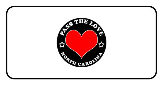 Red heart logo with Pass The Love North Carolina text on a black circular background