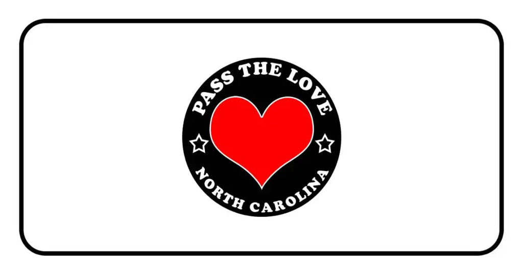 Red heart logo with Pass The Love North Carolina text on a black circular background