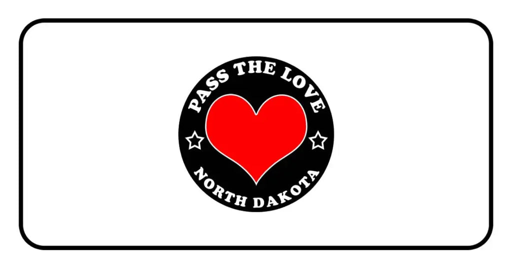 Black badge with red heart and text Pass The Love North Dakota on paid cards
