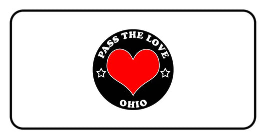 Circular black badge featuring PASS THE LOVE OHIO text and heart design for clothing