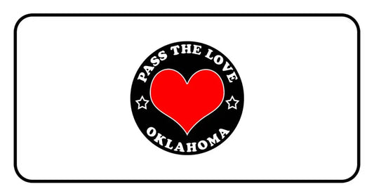 Black badge with red heart and Pass The Love Oklahoma text for paid cards and clothing