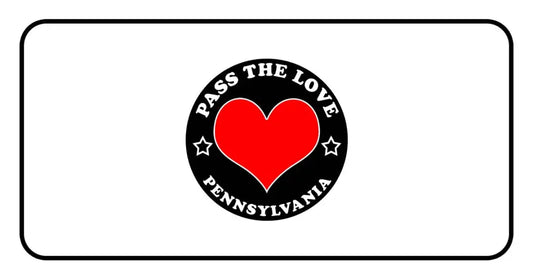 Black circular badge with red heart and text Pass The Love Pennsylvania, symbolizing love