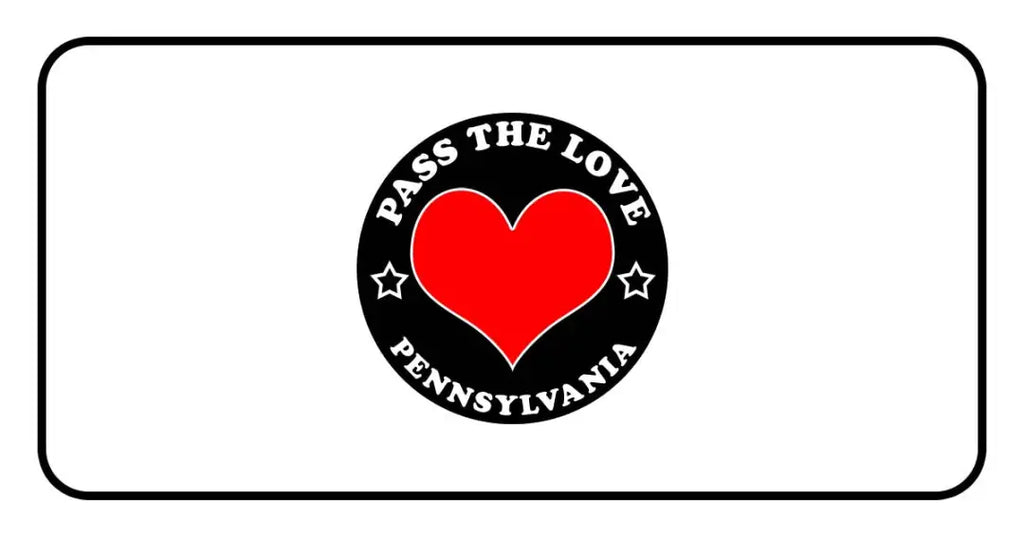 Black circular badge with red heart and text Pass The Love Pennsylvania, symbolizing love