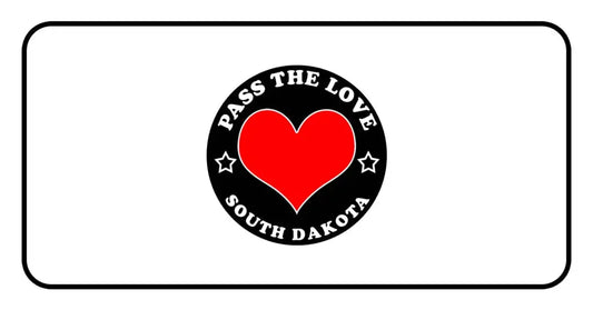 Black badge with red heart and text Pass The Love South Dakota for paid cards