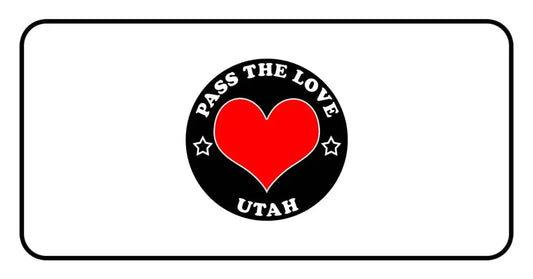 Black badge with PASS THE LOVE UTAH text and heart, perfect for love-themed Utah clothing