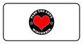 Black circular badge with red heart and text Pass The Love Wisconsin, stars accent included